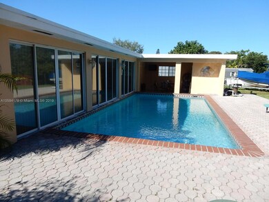 Pool and pavered deck with covered patio