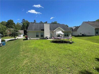 Rear view of house with a large level backyard, a great play/entertaining space.