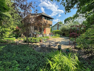 PRIVATE FENCED FLAGSTONE COURTYARD WITH PERENNIAL