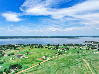 Aerial overview of property's location with a large body of water