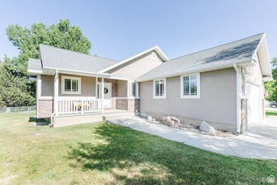 Ranch-style house with covered porch, an attached garage, stucco siding, and a shingled roof