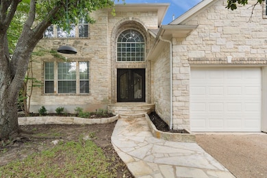 Doorway to property featuring stone siding, an at