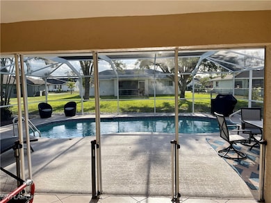 Outdoor pool with glass enclosure, a patio, and a