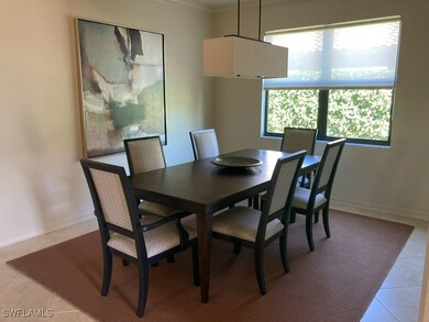 Tiled dining room featuring ornamental molding