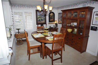 Separate dinning room with plantation shutters and travertine floor!