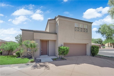 View of front of home featuring a garage, driveway, stucco siding, and a front yard