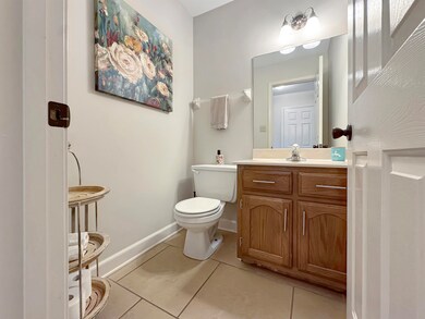 Bathroom with light tile patterned flooring and vanity