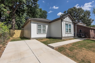 View of front of house with a patio area and board and batten siding