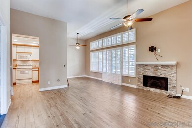 Living room with tiled fireplace looking through t
