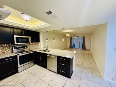 Kitchen featuring sink, light tile patterned floor