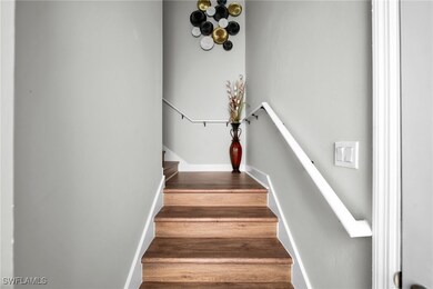 Staircase with baseboards and wood finished floors