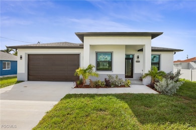 View of front of house with stucco siding, concrete driveway, and a garage