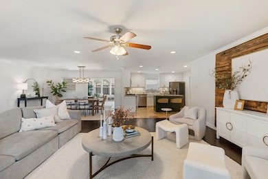 The open concept living area features an accent wa