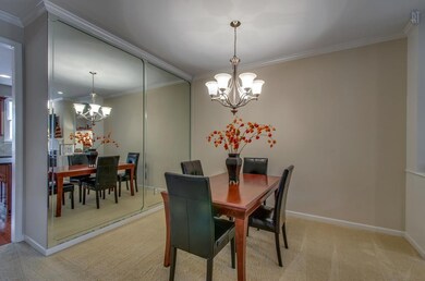 The formal dining space has a beautiful mirrored accent wall.
