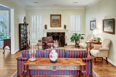 Formal living room where a duet of windows frame t