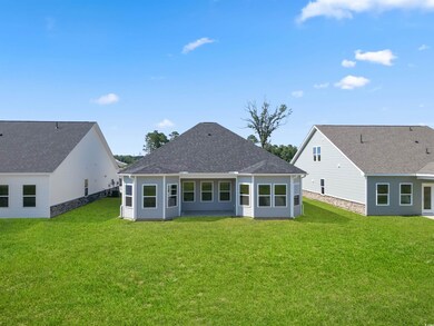 Rear view of property featuring a yard