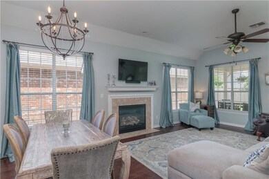 LIVING ROOM WITH FIREPLACE AND LARGE WINDOWS TO AD