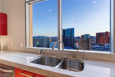 Kitchen featuring a sink and a city view