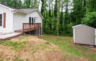 View of yard with an outdoor structure, a deck, an