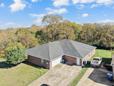 View from above of property featuring a heavily wooded area