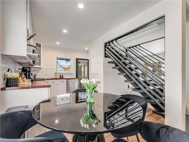 Dining room featuring stairs and recessed lighting