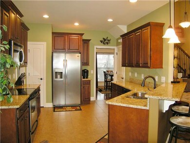 Gourmet kitchen with granite counter tops, snack bar, and two pantries. Great counter space for when you want to cook. Kitchen open to great room so that you'll never feel all alone when entertaining or chatting with family. 