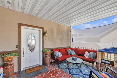 Doorway to property featuring outdoor lounge area, stucco siding, and a patio