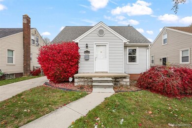 View of front facade with roof with shingles and a front lawn