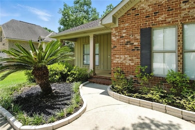 Entrance to property featuring brick siding, board and batten siding, and a shingled roof