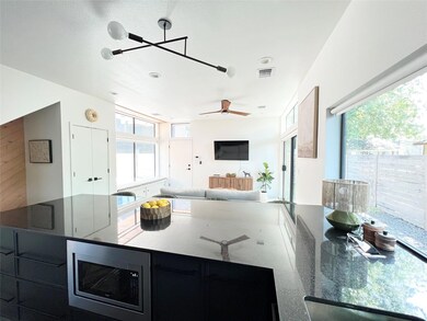 Kitchen featuring dark cabinetry, visible vents, 