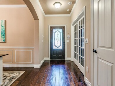 Entryway with dark wood-type flooring and ornament