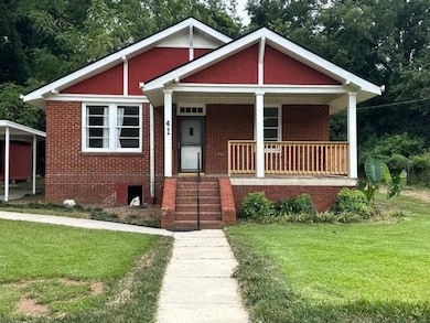 View of front of property with brick siding, a fro