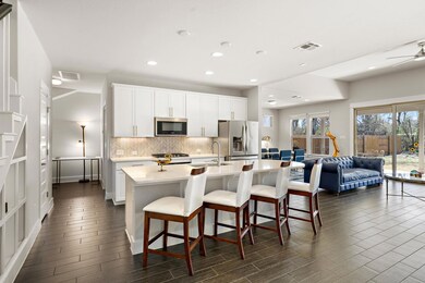 Kitchen with a sink, visible vents, backsplash, a