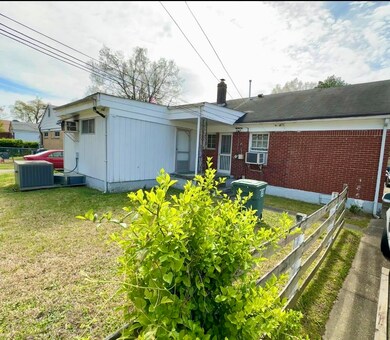 Rear view of property featuring a yard and central