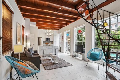 Light-filled open living space on the first floor with view of the private pool