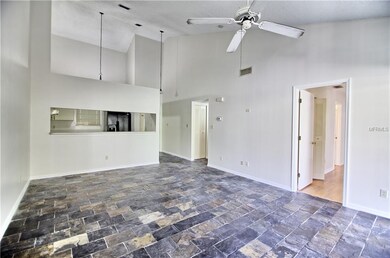 View of the living room, kitchen, and entrance.