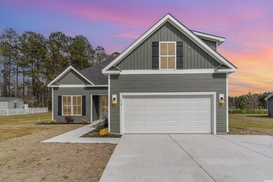 View of front of house with a front yard, an attac