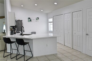 Kitchen featuring light tile patterned floors, a b