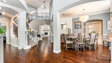 Dining space with ornamental molding and dark hard