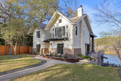 View of front facade featuring stucco siding, fen