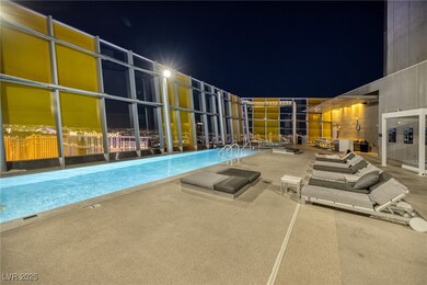 Pool at twilight featuring a community pool and a