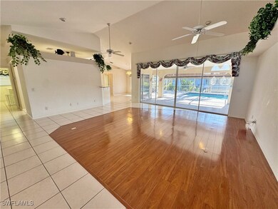 Unfurnished room featuring light hardwood / wood-style floors, ceiling fan, and lofted ceiling