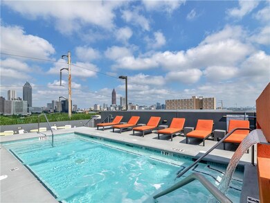 Community pool with a patio and a skyline view