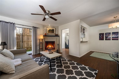 Living room with a textured ceiling, ceiling fan, 