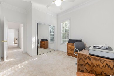 Carpeted office space featuring ornamental molding
