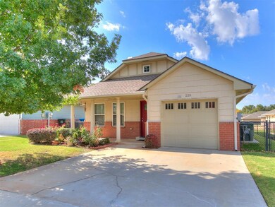 View of front of home with a front lawn and a gara