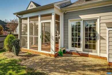 Stone patio in fenced rear yard features gas line 