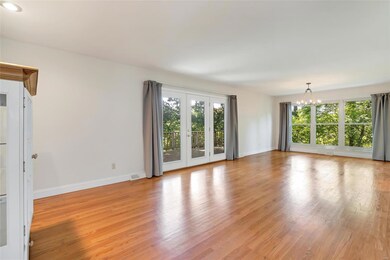 Spacious living area 1 with hardwood and entrance 