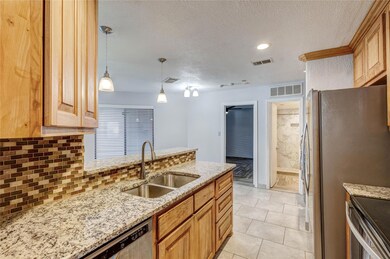 Kitchen featuring a sink, visible vents, tasteful 