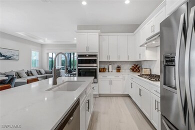 Kitchen with a sink, stainless steel appliances, u
